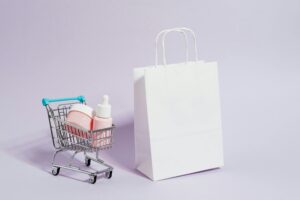 Shopping Cart Next to a White Paper Bag